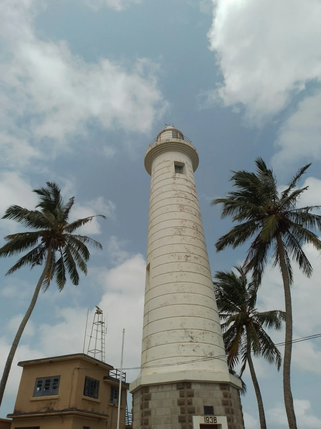 Galle lighthouse and palm trees